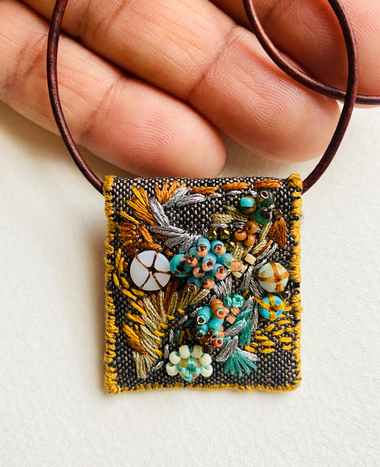 "Flying dove" Aqua, gold, tan embroidered, beaded textile necklace.