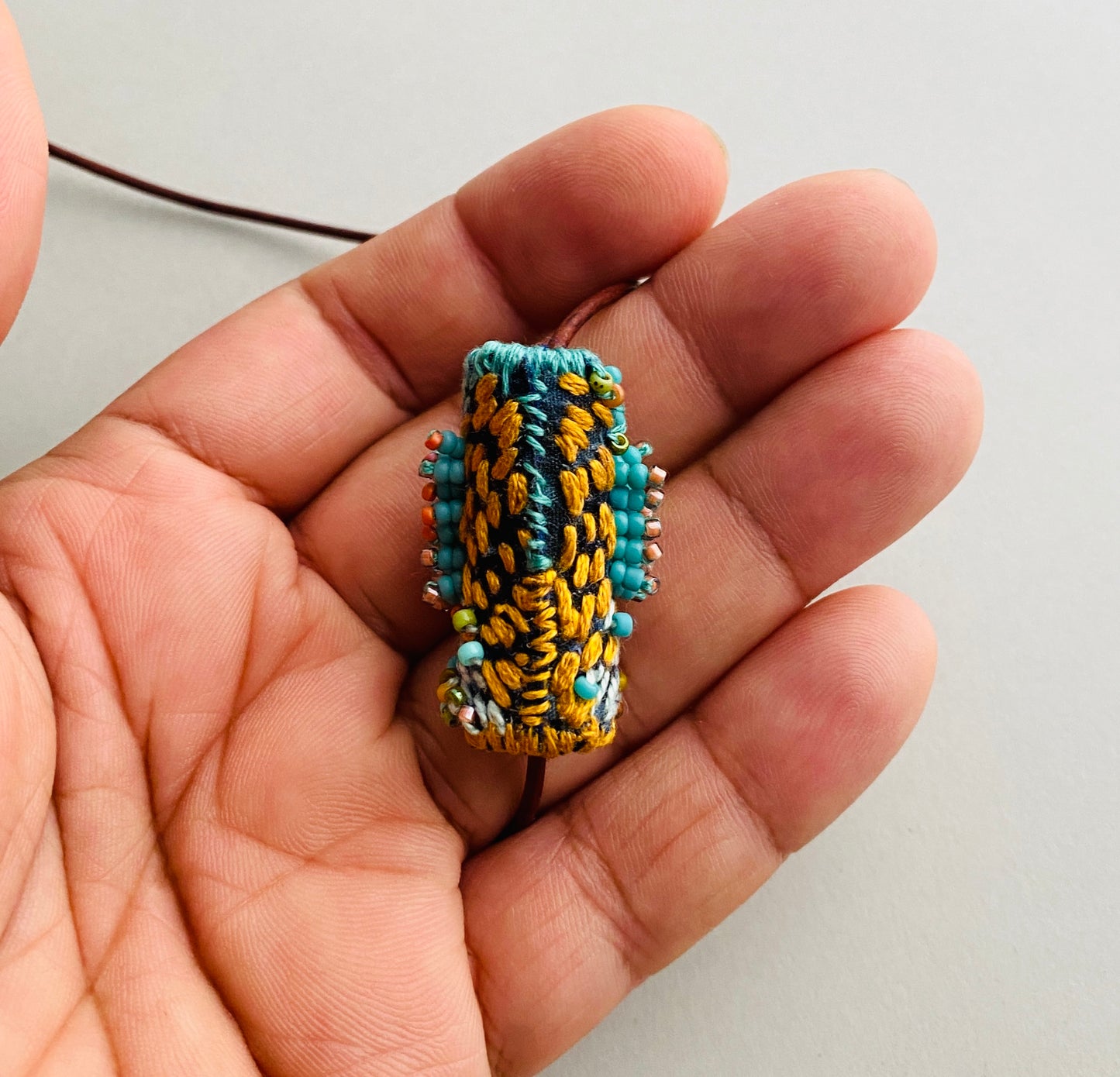 "Andromeda" turquoise embroidered and beaded textile necklace.
