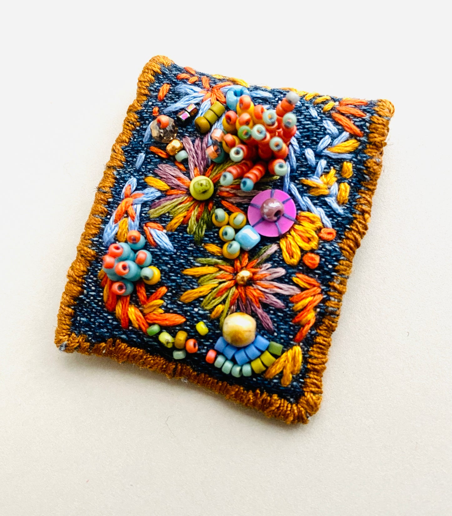 "Zinnias" Light blue and orange embroidered, beaded textile necklace.