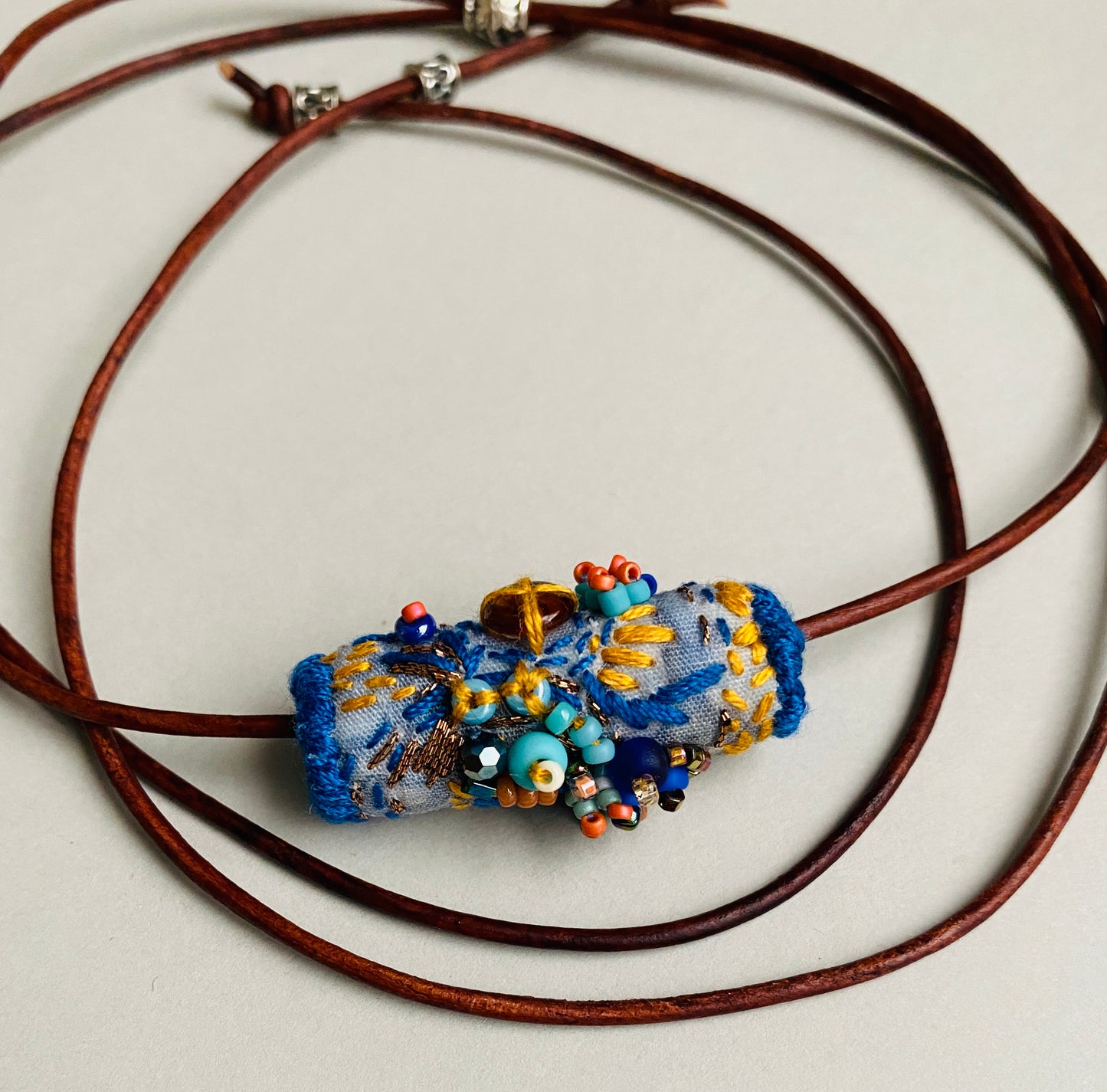 "Oceana" Blue, aqua and orange embroidered and beaded textile necklace.