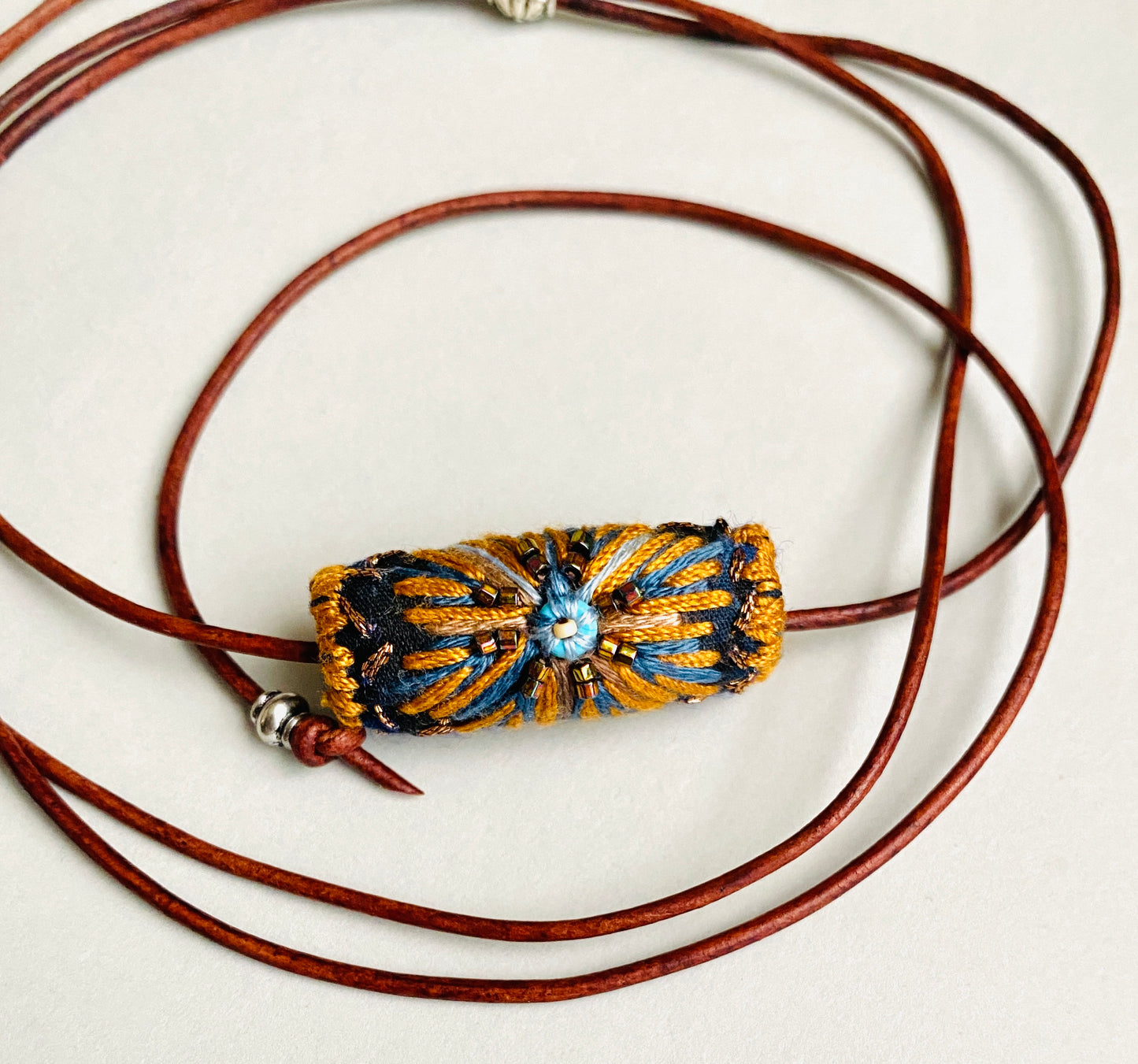 "Night star" textile necklace in copper and blue