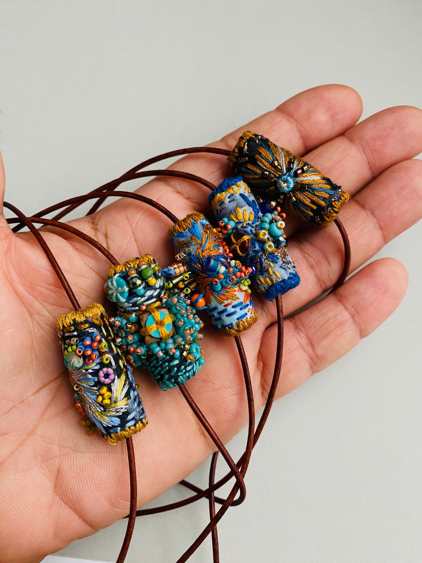 "Oceana" Blue, aqua and orange embroidered and beaded textile necklace.