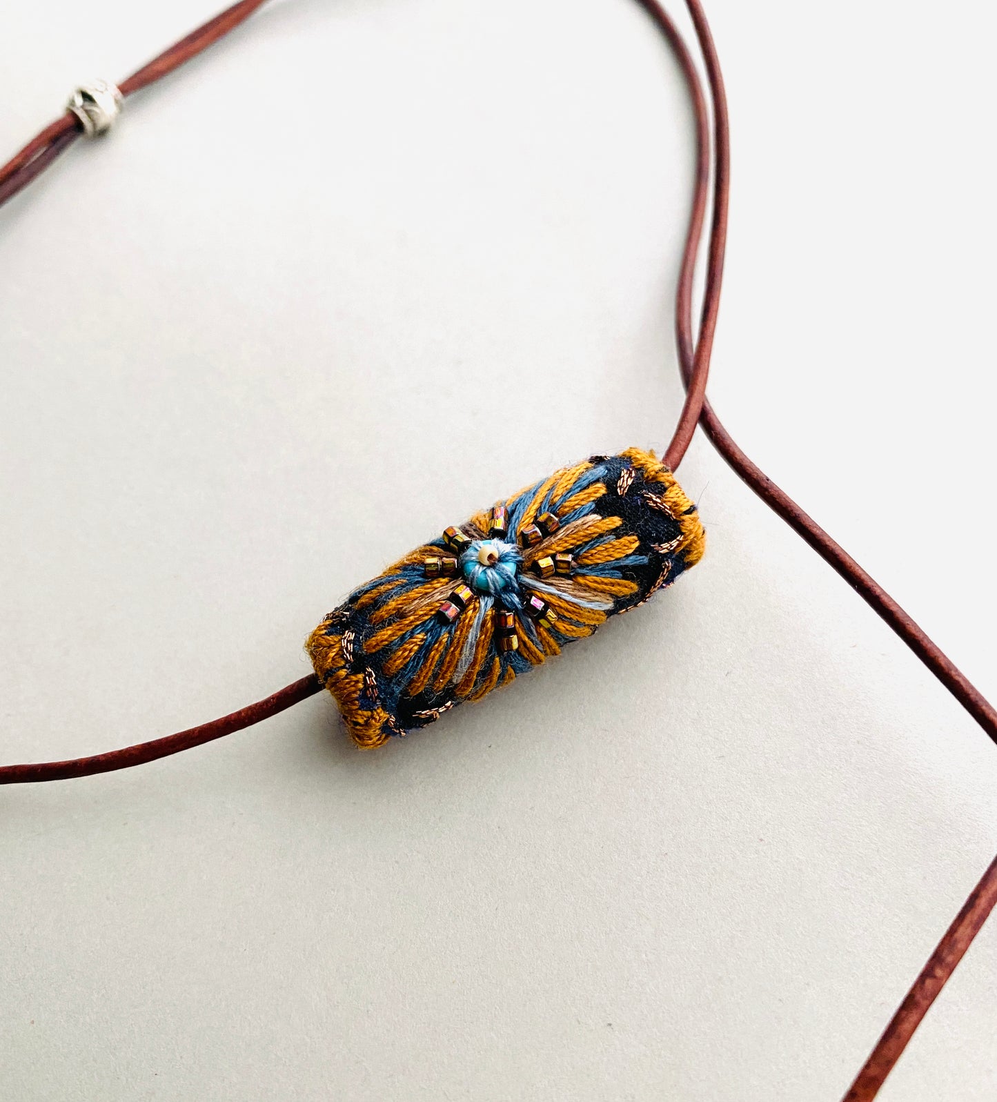 "Night star" textile necklace in copper and blue
